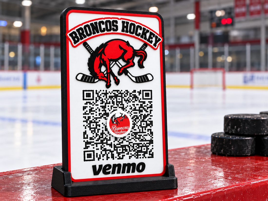 Broncos Hockey scan-or-tap payment sign standing on the boards at an ice rink